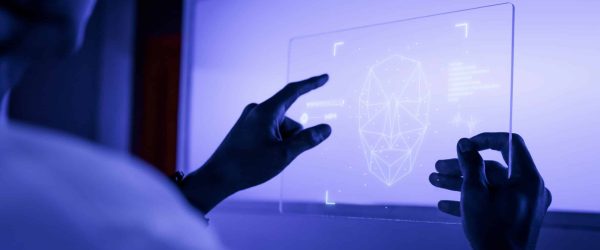 Designer using a transparent digital tablet screen futuristic technology